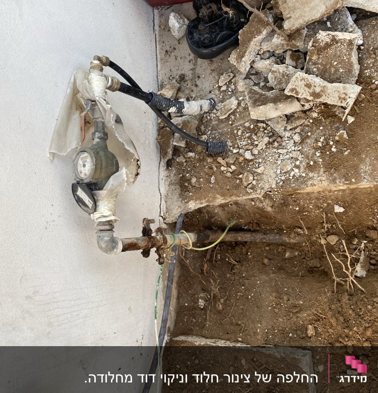 מד מים וצינורות חשופים בעבודת אינסטלציה